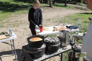 A woman cooks in camp