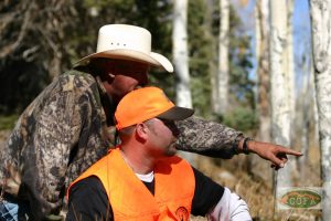 A man teaches another man to hunt